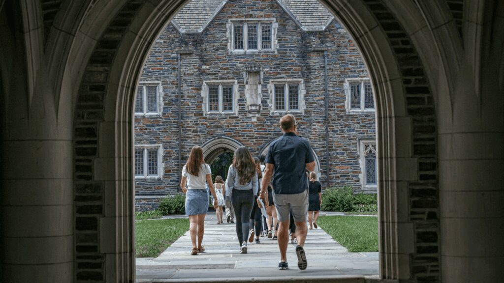Students walking through Duke arch